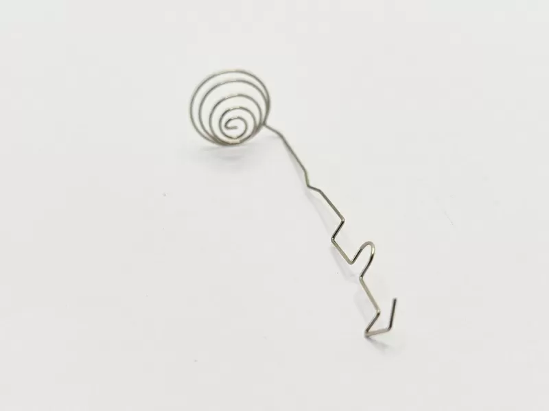 Metal Spring Contact with Coil Spring Buffer and Geometrically Bent Contact Arm